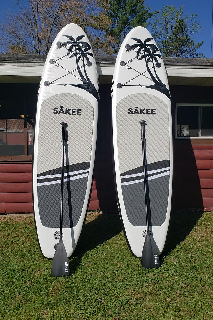 A picture of two Sakee white and grey Paddle Boards